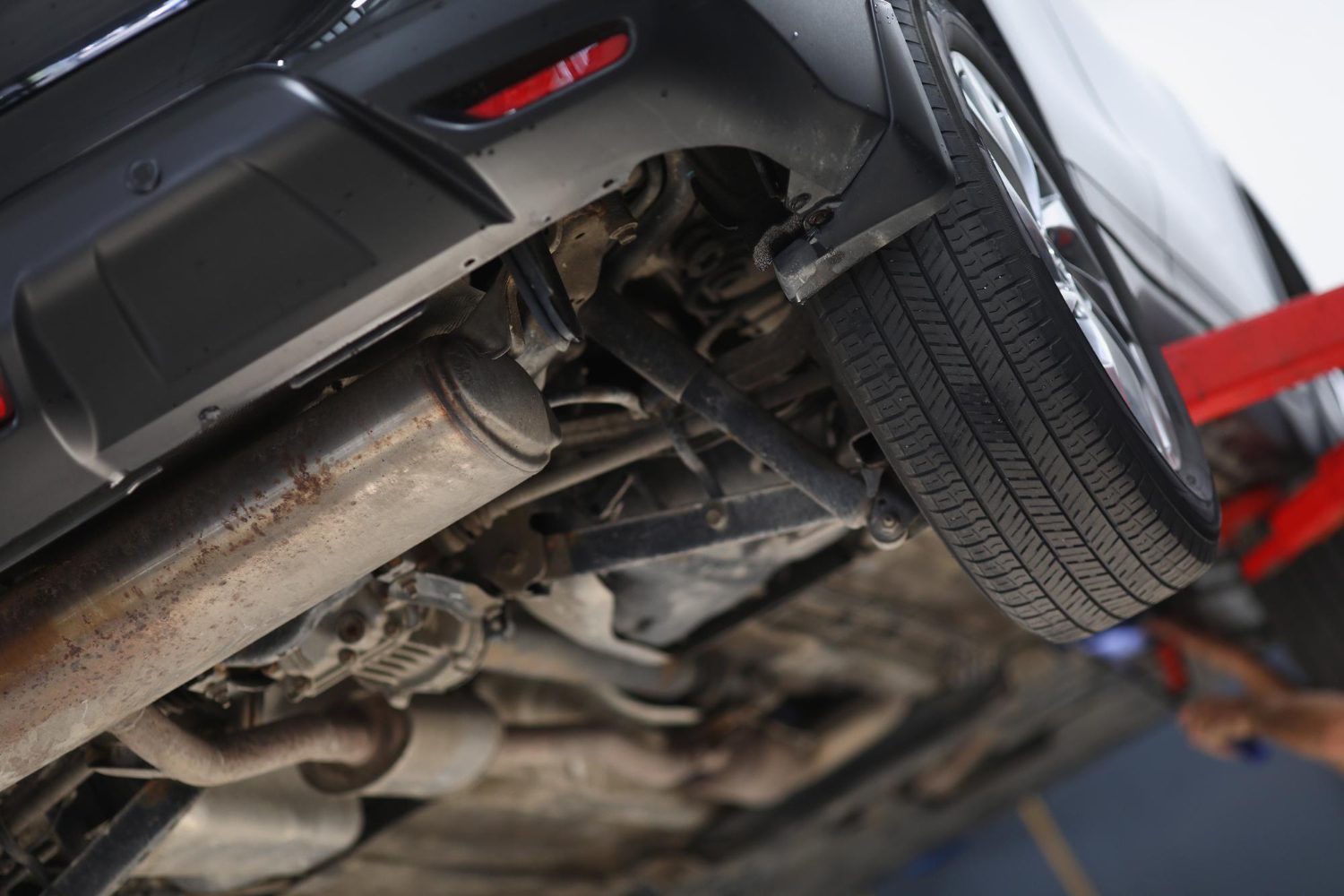 car-lifted-maintenance-service-checkup-undercarriage-automobile-bottom-view car-lifted-maintenance-service-checkup-undercarriage-automobile-bottom-view