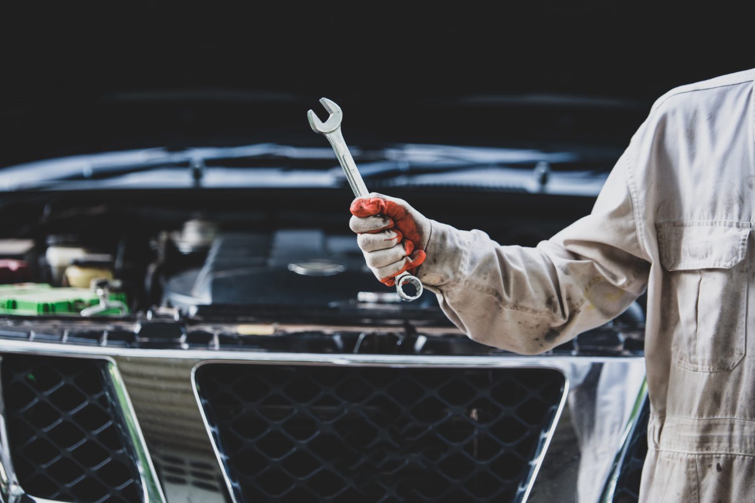 car-repairman-wearing-white-uniform-standing-holding-wrench-that-is-essential-tool-mechanic Auto & Tire