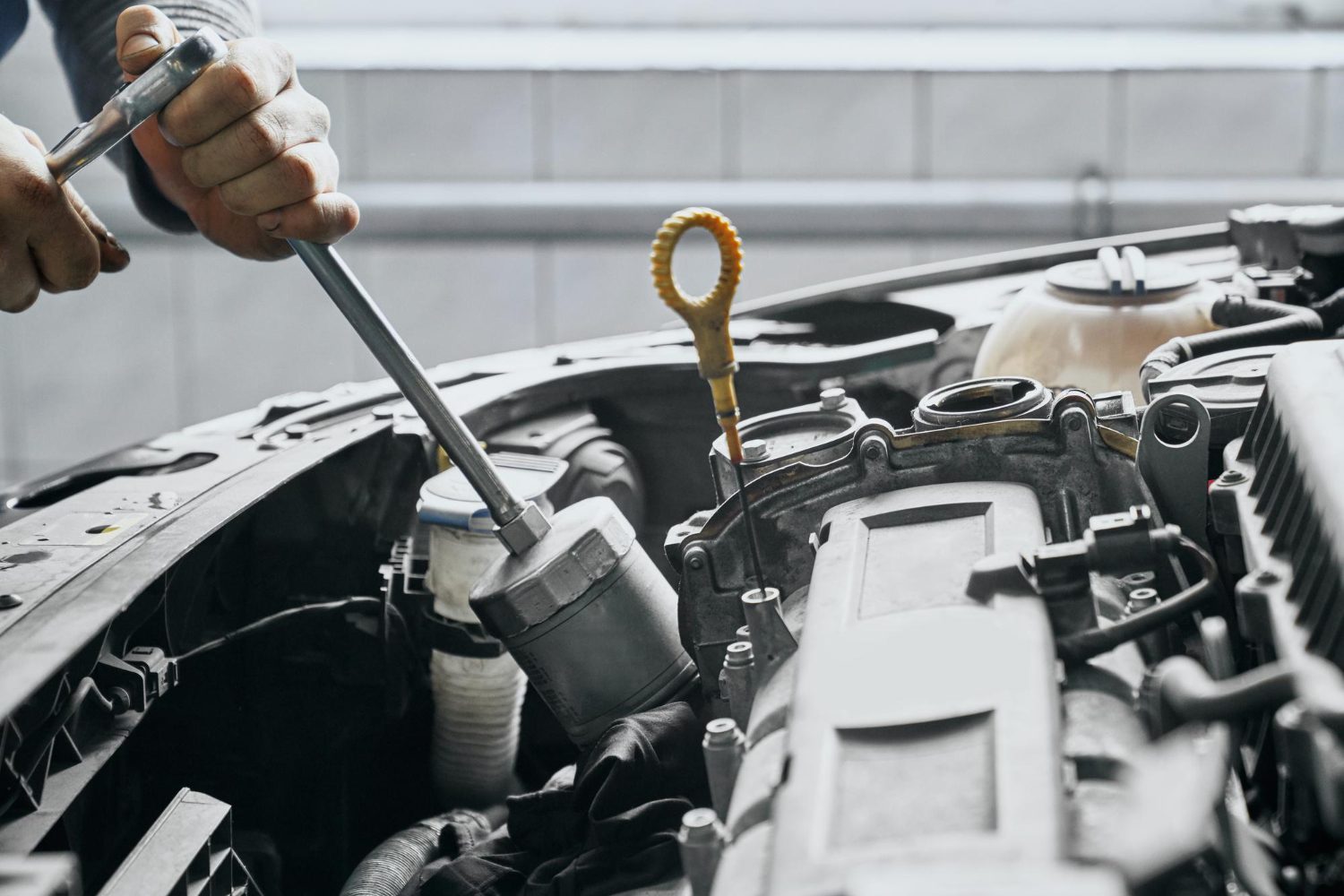 close-up-man-s-hands-tighten-piston-cylinder-by-wrench Auto & Tire