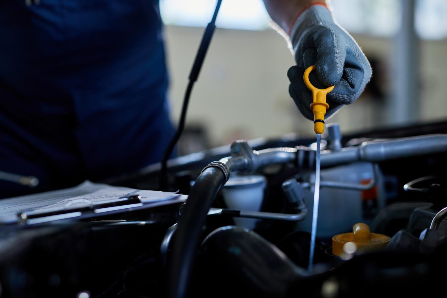 closeup-auto-repairman-checking-car-oil-workshop get in touch with us